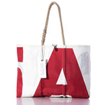 The Sea Bags Vintage A9 Large Tote features a bold red and white geometric pattern, hand-spliced rope handles, and a signature white SEABAGS tag. Proudly made in Maine from recycled sailcloth, this spacious tote is displayed against a crisp white background. by Sea Bags