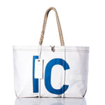 Sea Bags Vintage Interclub Large Tote features a white sailcloth design with a bold blue letter C on the front, sturdy rope handles, and an attached white tag. Handmade in Maine from durable recycled sailcloth, this tote blends classic style with genuine nautical heritage—photographed against a white background. by Sea Bags