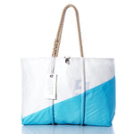 The Sea Bags Vintage Blue and White Large Tote is a Maine handcrafted bag featuring white and light blue panels, thick hand-spliced rope handles, and a tag hanging from one handle. Shown against a white background, this tote combines timeless style with the durable craftsmanship Sea Bags is known for. by Sea Bags