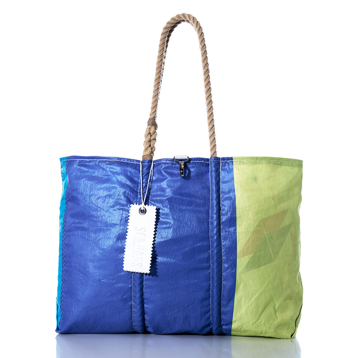 The Sea Bags Vintage Blue and Green Large Tote features blue and green panels, hand-spliced rope handles, and a white tag. Handcrafted in Maine from repurposed materials, this tote bag stands on a white surface with a plain background. by Sea Bags