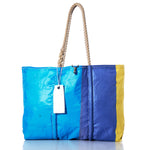 The Sea Bags Vintage Blue and Yellow Large Tote features hand-spliced rope handles, distinctive blue and yellow panels, and a white rectangular tag. Handcrafted in Maine, this bag blends style and practicality, echoing the charm of a classic vintage sail tote. by Sea Bags