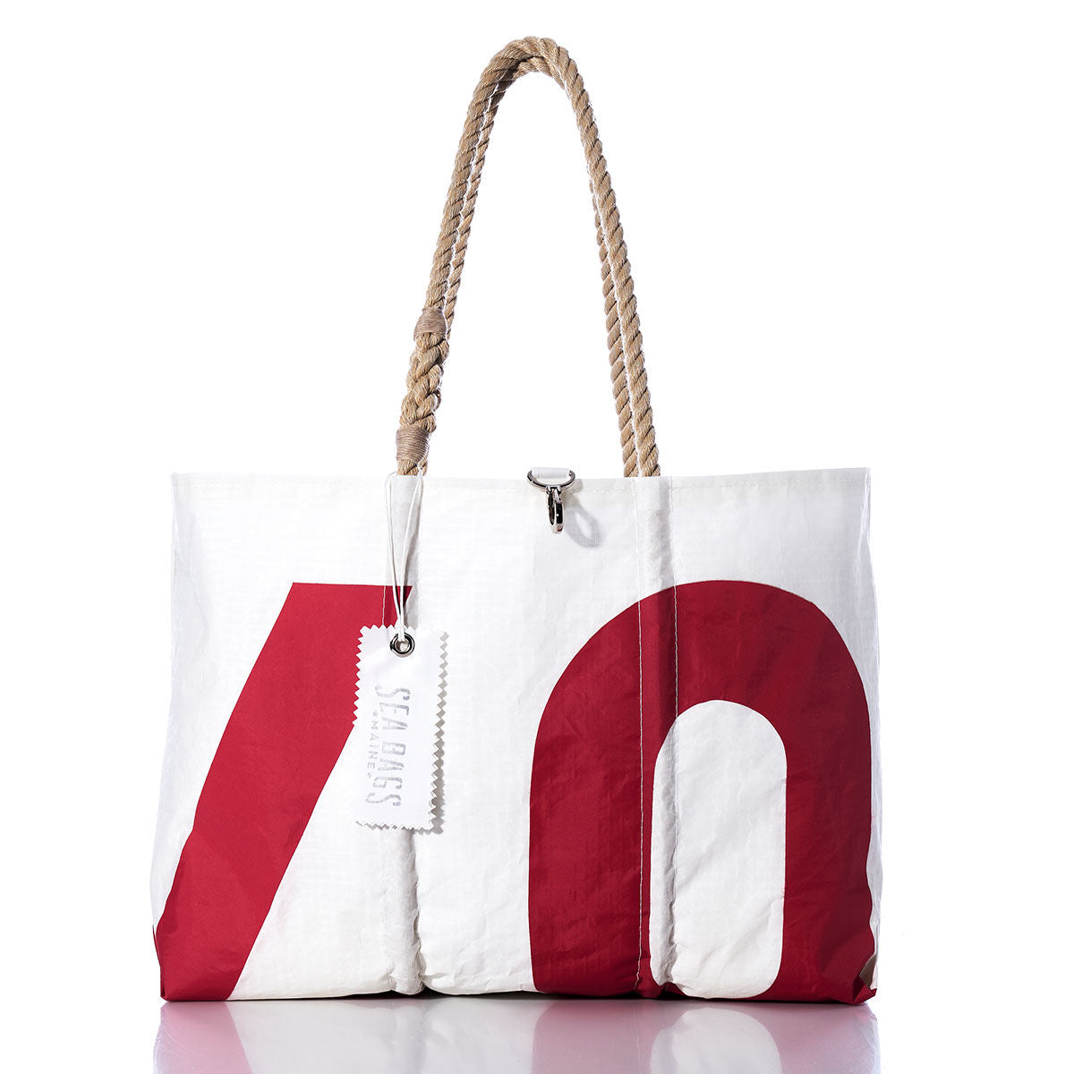 The Vintage 07 Large Tote by Sea Bags features bold red lettering on white sailcloth, rope handles, and a signature Sea Bags tag—each one is handmade in Maine. by Sea Bags