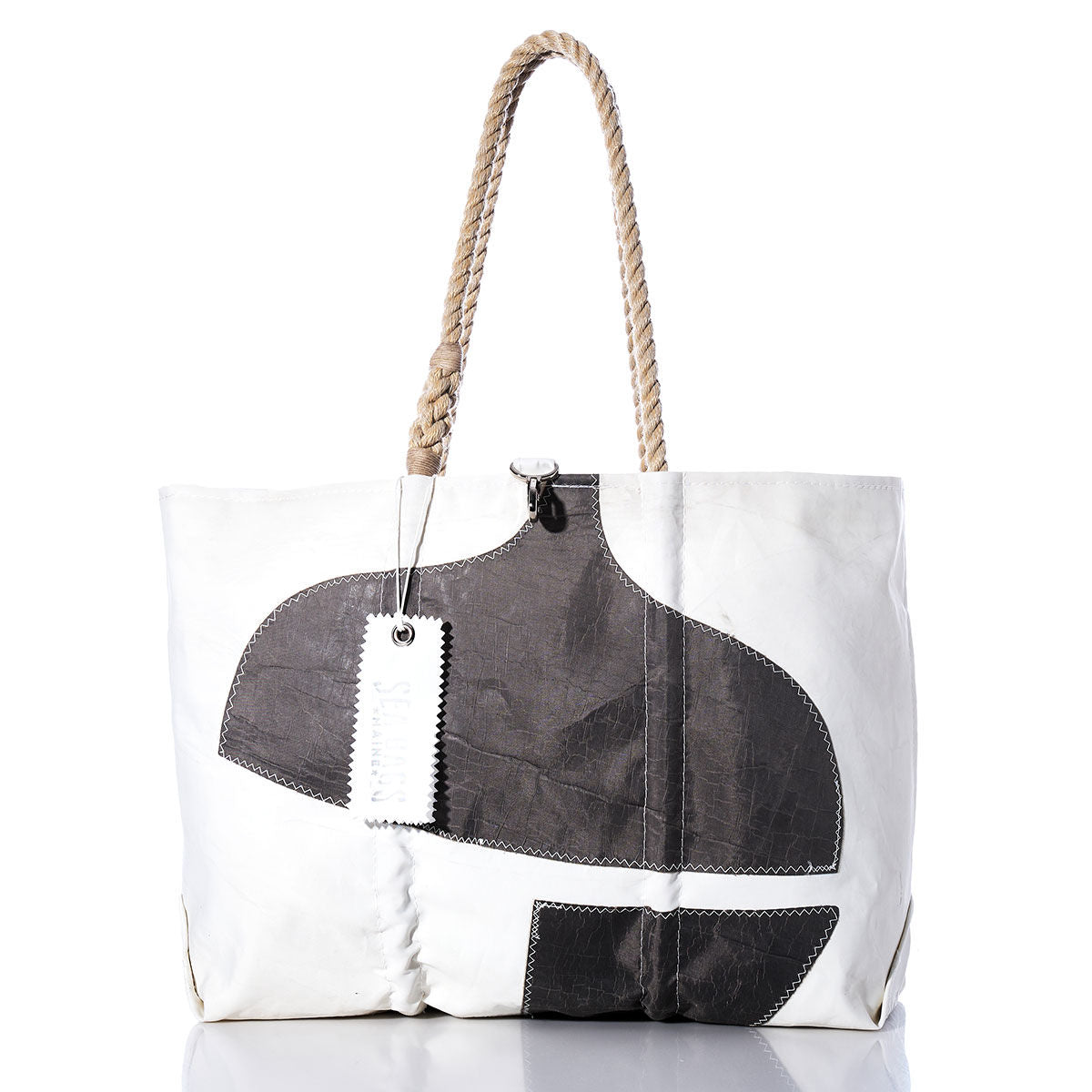 Sea Bags Vintage Pacific Seacraft Large Tote—features a white body, thick rope handles, black abstract shapes on the front, and two rectangular tags near the handle; inspired by classic sailboat tote bag designs. by Sea Bags