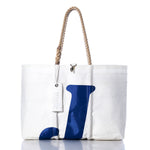 Sea Bags Vintage J70 Large Tote, handcrafted in Maine from white sailcloth with sturdy rope handles, features a bold blue letter J on the front and includes a hang tag attached to one handle. by Sea Bags