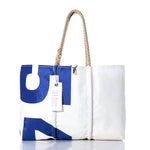 Sea Bags Vintage 541 Large Tote—a white and blue bag featuring hand-spliced rope handles, a zipper pocket, and a tag hanging from one handle—is displayed on a white background. This authentic Maine-made tote is inspired by the classic vintage sail bag design. by Sea Bags