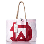 Introducing the Vintage Melges Large Tote by Sea Bags—a Maine-crafted white tote featuring a striking red graphic, hand-spliced rope handles, and a signature white Sea Bags tag for a blend of durability and coastal charm. by Sea Bags