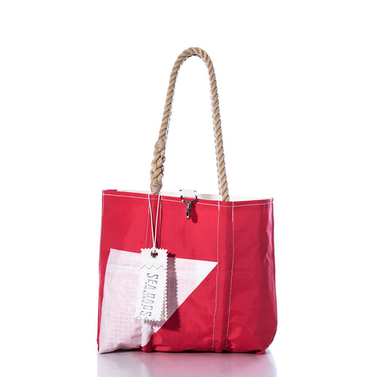 Vintage Pink and White Handbag by Sea Bags, featuring a white triangular patch, hemp rope handles, contrasting white stitching, and a signature SEA BAGS tag attached to the handle—displayed on a white background. This style recalls classic sail insignias and vintage handbag designs. by Sea Bags