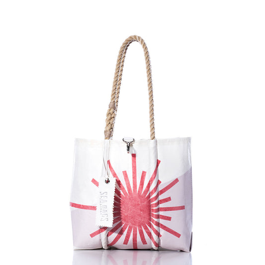 The Sea Bags Vintage Laser Handbag is a white tote adorned with a pink sunburst design, featuring sturdy hemp rope handles inspired by vintage laser handbags and finished with a signature Sea Bags tag; shown here against a white background. by Sea Bags