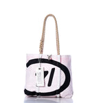 The Vintage C14 Handbag by Sea Bags features hemp rope handles, a pink and white body, bold black graphics inspired by classic sail insignias, and a branded Sea Bags tag. by Sea Bags