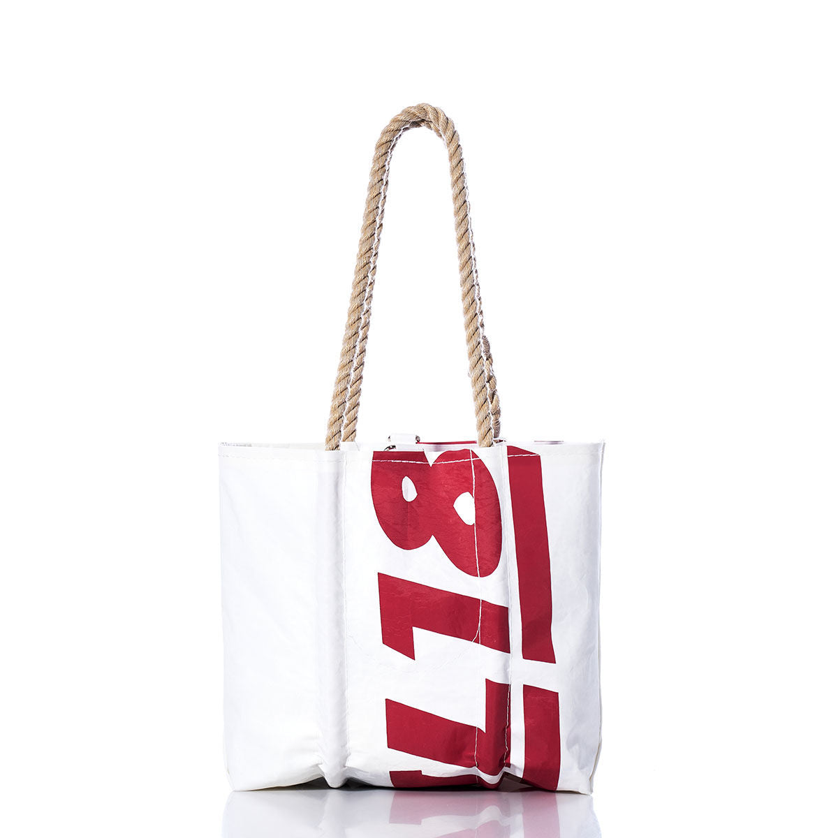 Sea Bags Vintage Ideal 18 Handbag—a white tote featuring thick hemp rope handles and bold red sail insignias printed vertically on the front, photographed against a white background. by Sea Bags