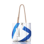Vintage Blue 17 Handbag by Sea Bags, featuring thick hemp rope handles, a blue geometric pattern inspired by classic sail insignias, and an attached Sea Bags branded tag. Displayed against a white background. by Sea Bags