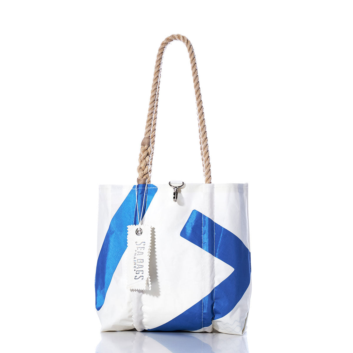 Vintage Blue 17 Handbag by Sea Bags, featuring thick hemp rope handles, a blue geometric pattern inspired by classic sail insignias, and an attached Sea Bags branded tag. Displayed against a white background. by Sea Bags