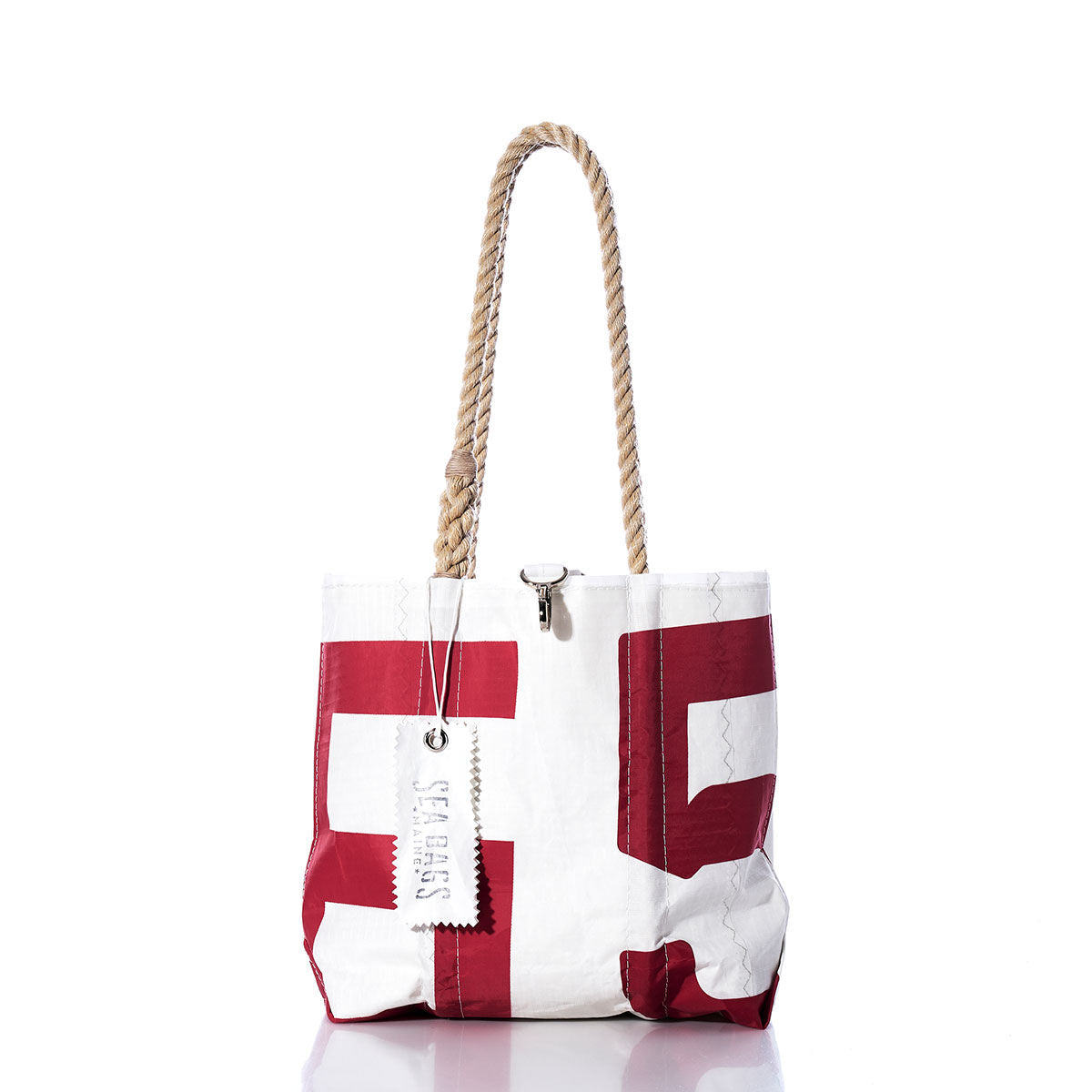 Vintage 65 Handbag by Sea Bags, featuring bold red lettering, a sail insignia, sturdy hemp rope handles, and a Sea Bags tag attached to one handle; displayed against a white background. by Sea Bags