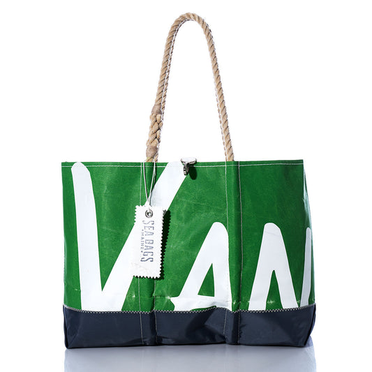Vintage VAN Ogunquit Beach Tote by Sea Bags in green and black, crafted from recycled sail cloth with rope handles and a white tag attached, displayed on a reflective white background. by Sea Bags