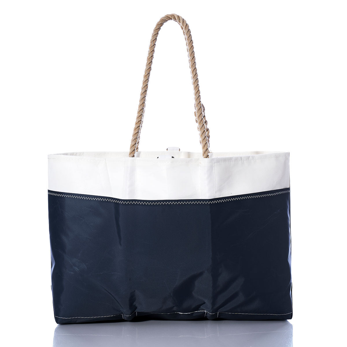 The Sea Bags Vintage Catalina 445 Ogunquit Beach Tote is a large beach tote bag made from recycled sail cloth, designed with a white top, navy blue bottom, and thick twisted rope handles, displayed on a white background. by Sea Bags