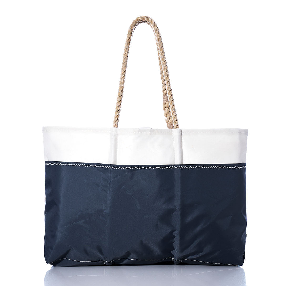 A Sea Bags Vintage Lightning Ogunquit Beach Tote, featuring navy blue and white hues with rope handles and crafted from recycled sail cloth, is photographed against a white background. by Sea Bags