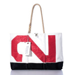 Introducing the Vintage Red 2 Ogunquit Beach Tote by Sea Bags—a white tote bag crafted from recycled sail cloth, featuring a bold red N on the front, durable rope handles, and a white Sea Bags tag—making it the perfect stylish beach accessory, beautifully presented against a crisp white background. by Sea Bags