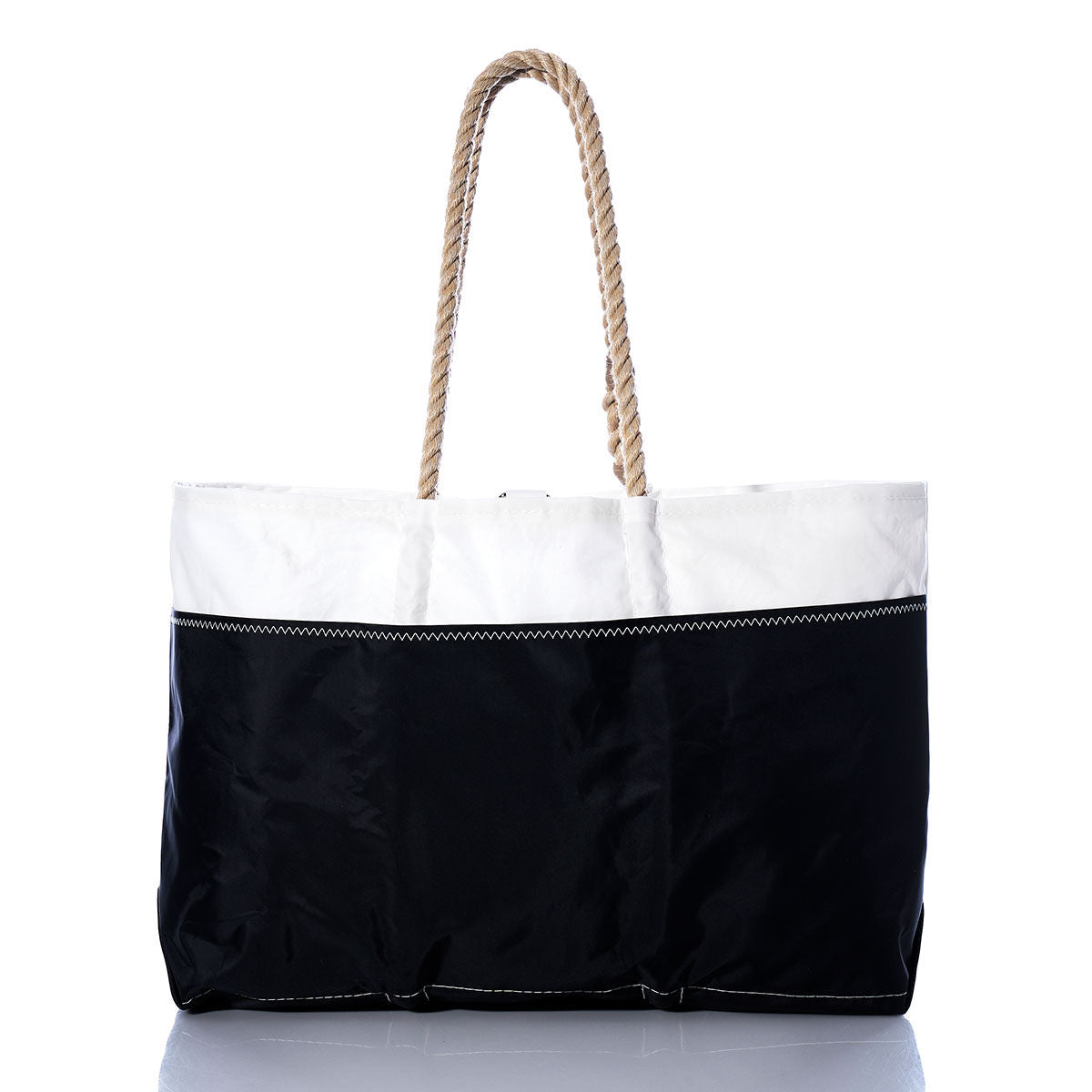 The Sea Bags Vintage Red 2 Ogunquit Beach Tote is a spacious bag made from recycled sail cloth, showcasing a white top, a black bottom, visible stitching, and thick twisted rope handles. The tote is photographed against a white background. by Sea Bags