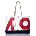 Sure Here is a rewritten sentence using your product data: The Sea Bags Vintage Red 49 Ogunquit Beach Tote features a striking red 49 design, a navy base, sturdy rope handles, and the signature Sea Bags tag on one handle, all crafted from recycled sail cloth for a truly unique beach accessory. by Sea Bags