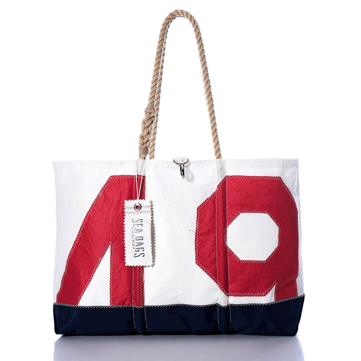 Sure Here is a rewritten sentence using your product data: The Sea Bags Vintage Red 49 Ogunquit Beach Tote features a striking red 49 design, a navy base, sturdy rope handles, and the signature Sea Bags tag on one handle, all crafted from recycled sail cloth for a truly unique beach accessory. by Sea Bags
