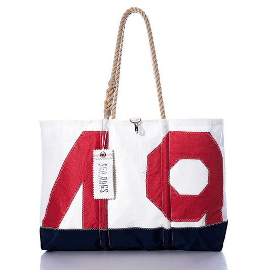 Sure Here is a rewritten sentence using your product data: The Sea Bags Vintage Red 49 Ogunquit Beach Tote features a striking red 49 design, a navy base, sturdy rope handles, and the signature Sea Bags tag on one handle, all crafted from recycled sail cloth for a truly unique beach accessory. by Sea Bags