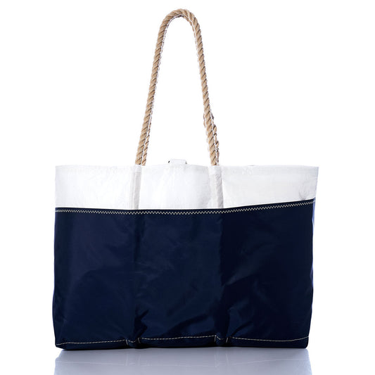Vintage red Ogunquit Beach Tote with thick rope handles, crafted from recycled sail cloth by Sea Bags, photographed against a white background. by Sea Bags
