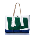 Introducing the Vintage Etchells Ogunquit Beach Tote by Sea Bags—a spacious tote bag featuring a green and white design, blue bottom edge, sturdy rope handles, and a distinctive white Sea Bags tag attached to the strap. Expertly crafted from recycled sail cloth, this eco-friendly tote blends durable style and sustainability for all your seaside adventures. by Sea Bags