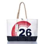 The Sea Bags Vintage Colgate 26 Ogunquit Beach Tote is a large white and black tote with rope handles, crafted from recycled sail cloth and adorned with a bold red and blue vintage Colgate 26 design. It features a SEA BAGS tag attached to one handle. by Sea Bags