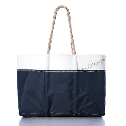 The Sea Bags Vintage Colgate 26 Ogunquit Beach Tote, crafted from recycled sail cloth and inspired by the classic Colgate 26, features a navy blue and white design with rope handles and zigzag stitching detail, set against a white background. by Sea Bags