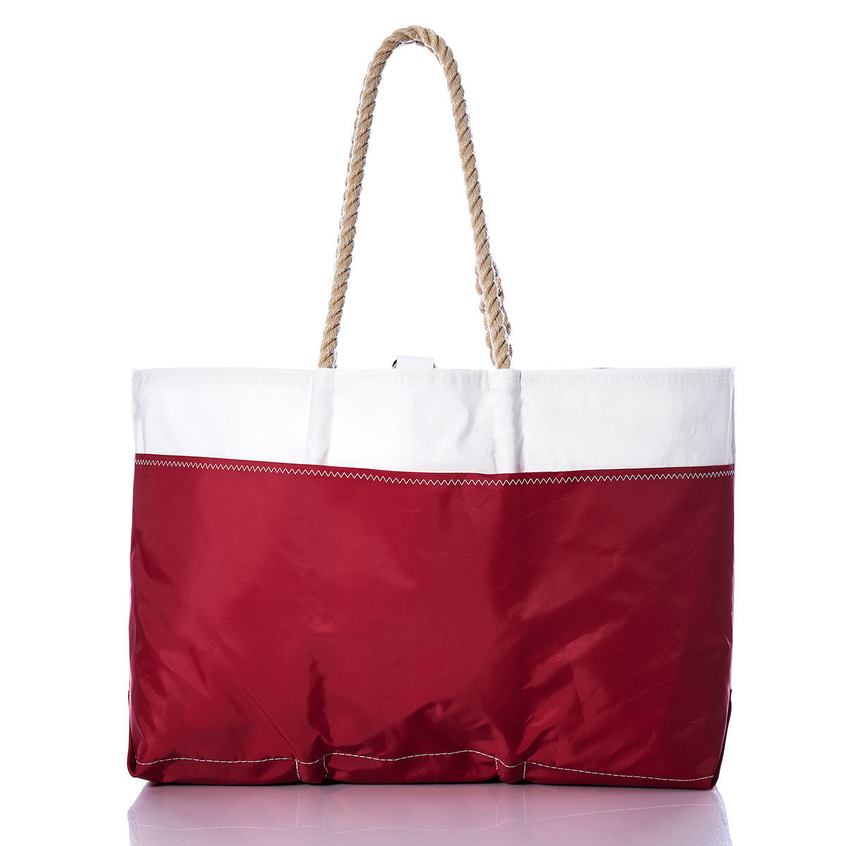 Showcased against a plain white background, the Sea Bags Vintage Blue M Ogunquit Beach Tote features a white top, vintage blue bottom, and sturdy rope handles. Crafted from recycled sail cloth, this stylish and sustainable tote is perfect for your seaside adventures. by Sea Bags