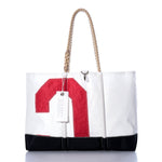 Sea Bags Vintage Red C Ogunquit Beach Tote is a white and black beach bag made from recycled sail cloth, designed with sturdy rope handles and adorned with a striking vintage red number 2 on the front, along with a signature Sea Bags tag. by Sea Bags