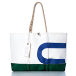 The Sea Bags Vintage USA Ogunquit Beach Tote, made from recycled sail cloth, features a large white and green design with blue partial lettering, a sturdy rope handle, and a white tag attached. It is photographed on a white background. by Sea Bags