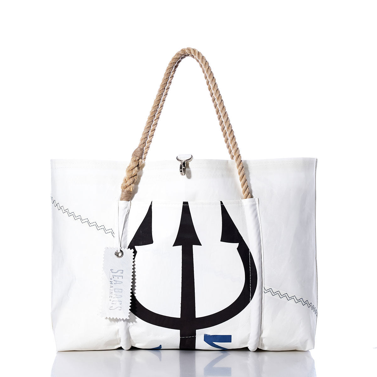 Handmade in Portland, Maine, the Sea Bags Vintage Black Trident Wharf Tote is crafted from recycled sails and features rope handles, distinctive zigzag stitching, and a bold black trident graphic. The tote includes a white tag labeled “Sea Bags” and is photographed against a white background. by Sea Bags