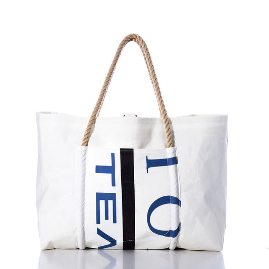 Vintage Black Trident Wharf Tote by Sea Bags, featuring a blue and black partial text design on white recycled sailcloth with two tan rope handles, photographed on a white background. Handmade in Portland, Maine, this tote blends nautical style with sustainable craftsmanship. by Sea Bags
