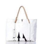 Introducing the Vintage Black Trident Wharf Tote by Sea Bags—a white handcrafted tote featuring rope handles, a metal clasp, and a bold black trident arrow design. Finished with a signature Sea Bags tag on the handle, this tote is proudly made in Portland, Maine from recycled sailcloth. The Vintage Black Trident Wharf Tote perfectly blends coastal durability with distinctive style. by Sea Bags
