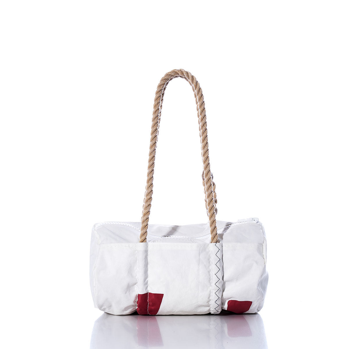 The Sea Bags Vintage Harbor 20 Baguette Bag is a white, rectangular accessory featuring two thick hemp rope handles and small red corner patches. Displayed on a reflective surface against a plain white background, this bag channels nautical charm and contemporary style, drawing inspiration from the classic vintage sail bag. by Sea Bags