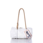 The Sea Bags Vintage Performance Sails Baguette Bag features a white rectangular design with a thick, hand-spliced hemp rope handle and a Performance Sailcloth tag attached; shown against a white background. by Sea Bags