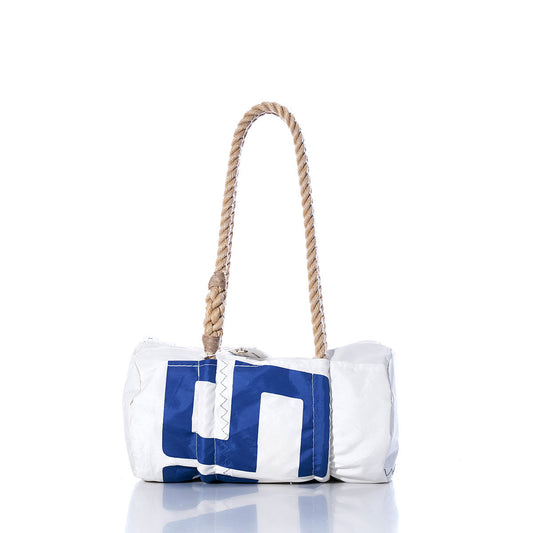 The Sea Bags Vintage 527 Baguette Bag is a white and blue cylindrical bag crafted from sailcloth, featuring subtle sail insignias and a hand-spliced hemp rope handle. It is displayed on a reflective surface against a white background. by Sea Bags