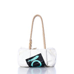 Vintage Quantum Baguette Bag by Sea Bags, featuring hemp rope handles and a black patch with a teal circular design inspired by classic sail insignias, displayed on a white background. by Sea Bags