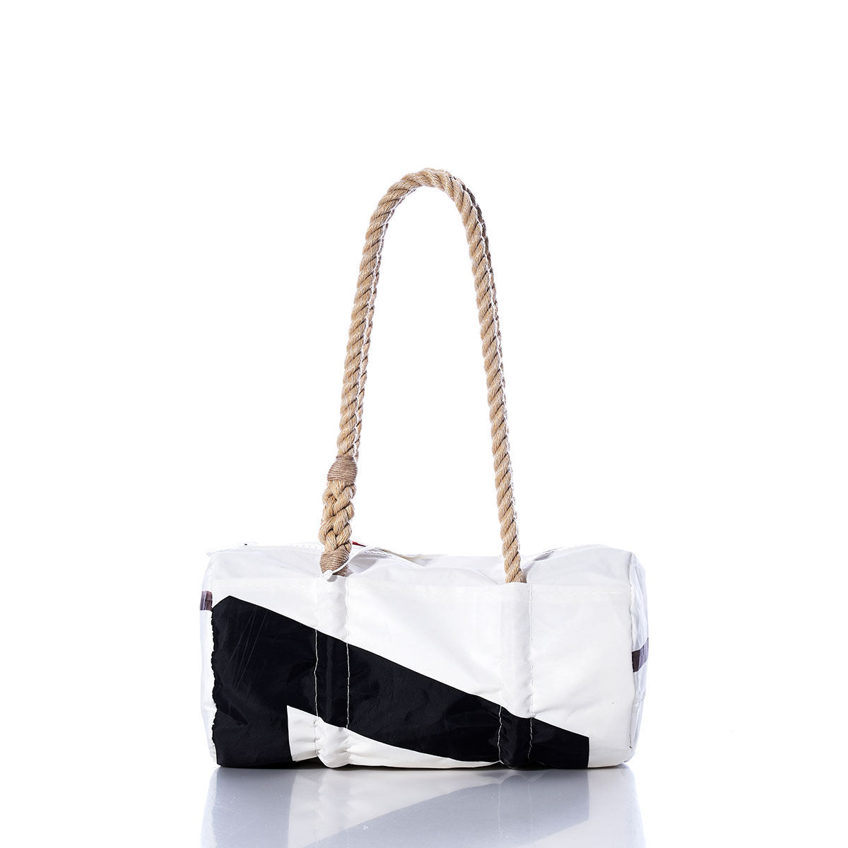 The Sea Bags Vintage Black 7 Baguette Bag is a white and black cylindrical bag featuring a thick, hand-spliced hemp rope handle. Displayed on a reflective surface against a white background, its classic vintage baguette shape is complemented by subtle sail insignias for a nautical touch. by Sea Bags