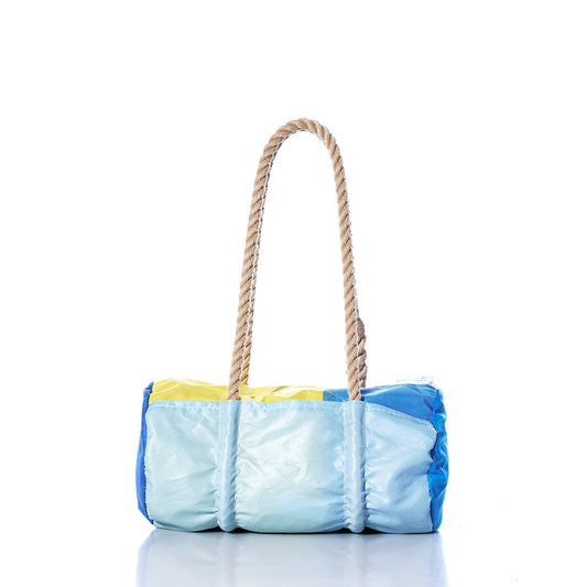 The Sea Bags Vintage Blue and Yellow Baguette Bag is a rectangular bag with a patchwork design in light blue, blue, and yellow panels, featuring two thick hand-spliced hemp rope handles crafted from recycled sails, shown against a white background. by Sea Bags