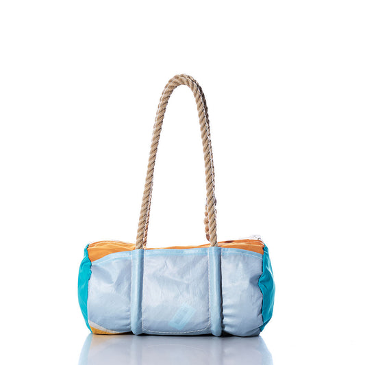 The Sea Bags Vintage Multicolor Baguette Bag is a cylindrical handbag made from recycled sails, showcasing a bold blue, orange, and turquoise patchwork design and two sturdy rope handles, shown against a white background. by Sea Bags