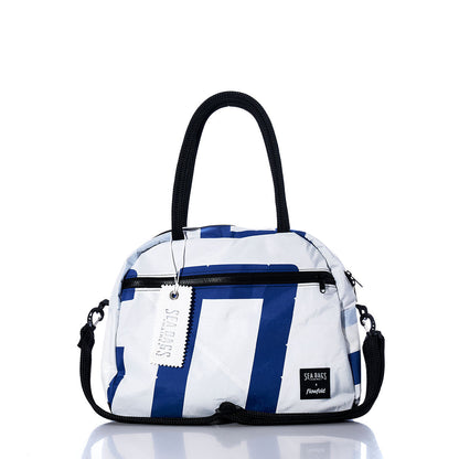 The Vintage Blue and White Essential Weekender Travel Bag by Sea Bags features a striking blue and white design with black handles and a shoulder strap, plus a front zipper pocket, tag, and the “Sea Bags” label—all set against a white background. Perfect as an overnight or carry-on bag for your next adventure. by Sea Bags