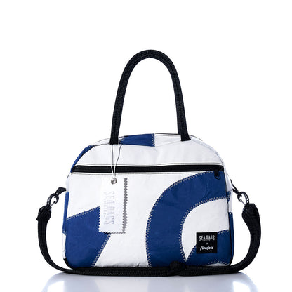 The Sea Bags Vintage Blue Numbers Essential Weekender Travel Bag features a compact blue and white design with black handles, a front zipper pocket, detachable shoulder strap, and a signature Sea Bags tag on the zipper—perfect as a stylish carryon inspired by vintage blue style for your next adventure. by Sea Bags