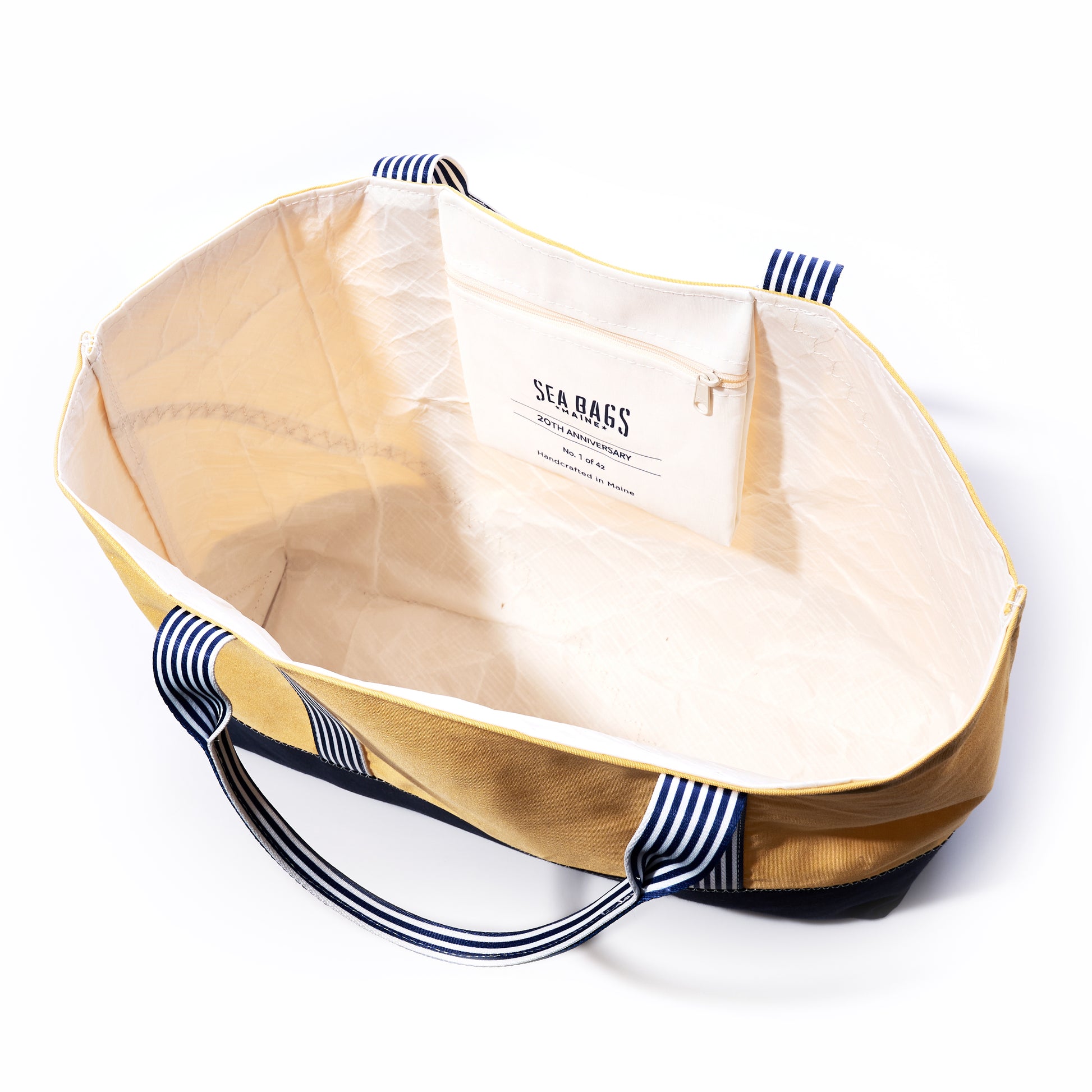 Beige tote bag with navy accents and 'Sea Bags' branding on a white background
