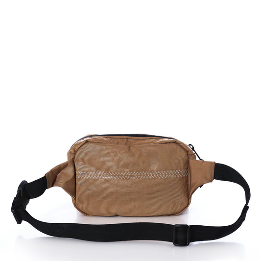 Vintage Caramel Tanbark Belt Bag in tan recycled sail cloth, featuring a black adjustable strap with buckle and horizontal zig-zag stitch detail on the front.