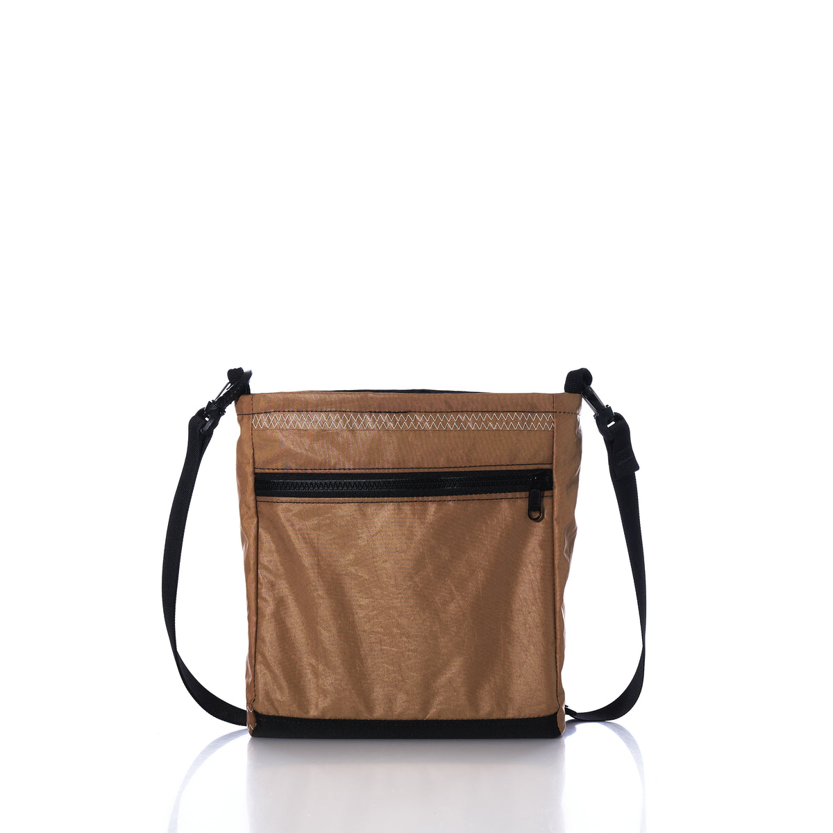 Vintage Caramel Tanbark Voyager Small Crossbody bag in caramel tanbark with a black zippered front pocket and an adjustable shoulder strap.