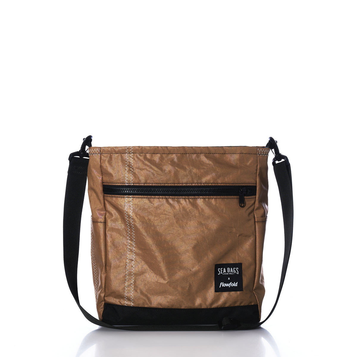 Vintage Caramel Tanbark Voyager Medium Crossbody bag in tan with a black zipper, black bottom panel, and black adjustable shoulder strap, crafted from vintage recycled sail cloth.
