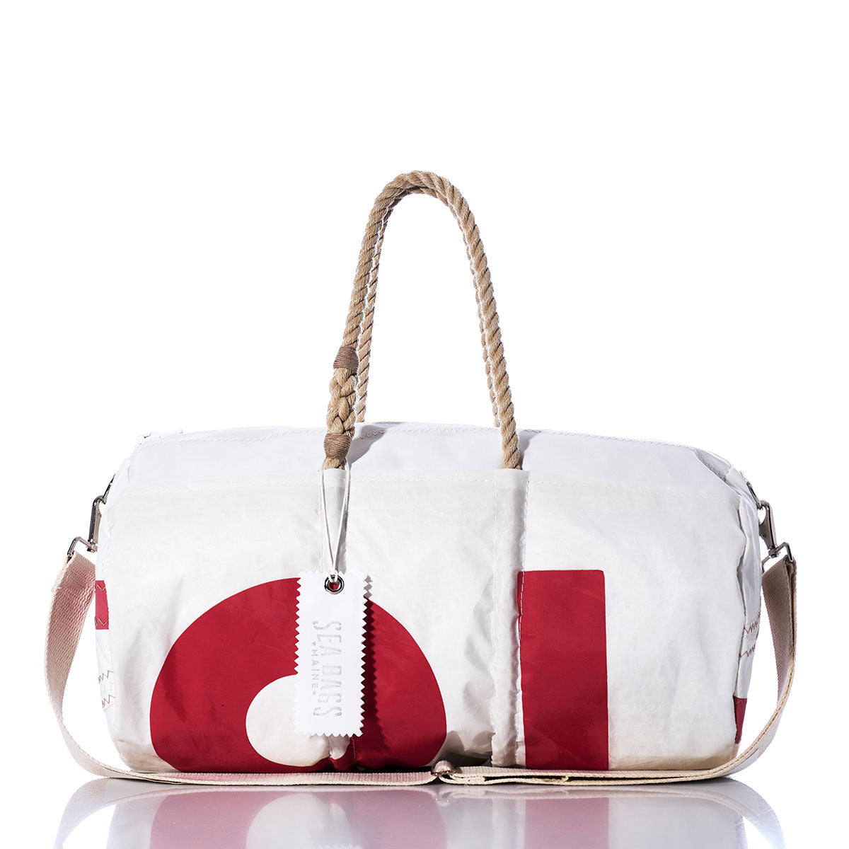 The Vintage 81 Duffel by Sea Bags is a white and red duffel bag crafted from recycled sail cloth, featuring sturdy hemp rope handles, a convenient shoulder strap, and a white tag labeled Sea Bags, shown against a white background. by Sea Bags