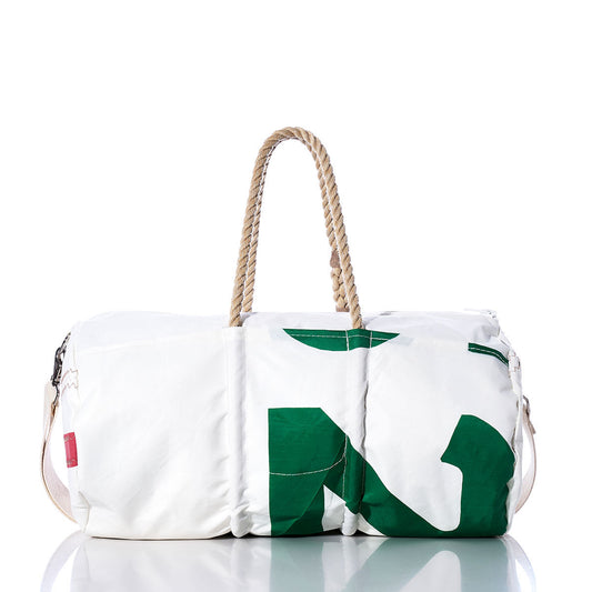 The Sea Bags Vintage 25 Duffel is a white bag with a green pattern, crafted from recycled sail cloth and adorned with distinctive sail insignias. It features sturdy rope handles and a convenient shoulder strap, shown on a reflective surface against a plain white background. by Sea Bags